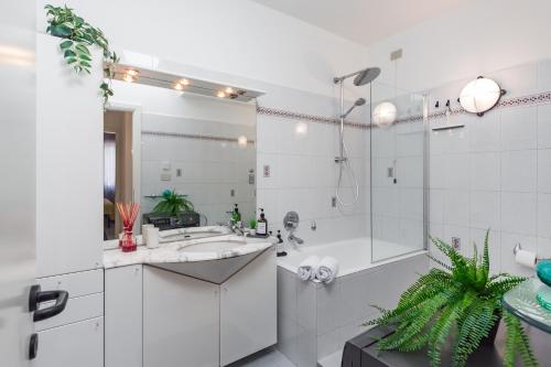 a white bathroom with a shower and a sink at Villetta con balcone - vicino Linate e stazione in Pioltello