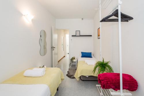 a room with two beds and a guitar on the wall at Villetta con balcone - vicino Linate e stazione in Pioltello