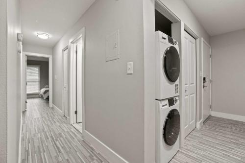 a laundry room with a washer and dryer on the wall at Stylish & Spacious Getaway Near Downtown in Rochester Hills