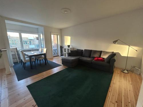 a living room with a couch and a table at Harbour Residence in Copenhagen