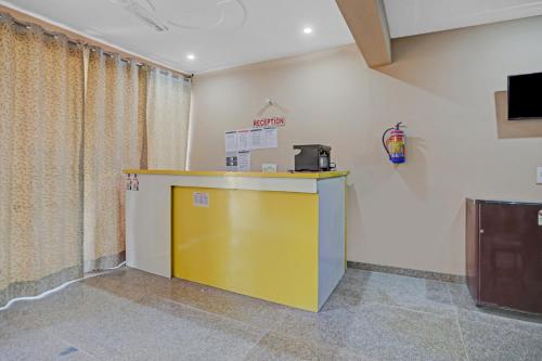 a room with a yellow counter in a room at Hotel O AKKI RESIDENCY in Noida