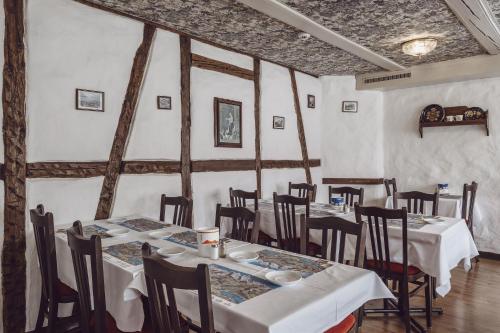 a restaurant with tables and chairs in a room at Hotel Chalet Swiss in Interlaken