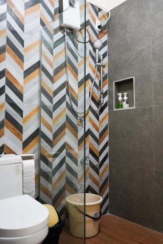 a bathroom with a shower with a toilet in it at Natos Residences - Los Angeles in Bacolod