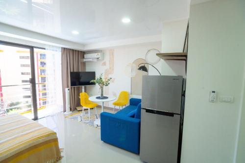 Camera con frigorifero, tavolo e sedie. di Pool View Tropic Studio a Ban Mai Salae