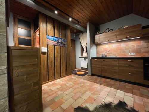 a kitchen with wooden cabinets and a counter top at Apartament DOLOMITI in Jaworki