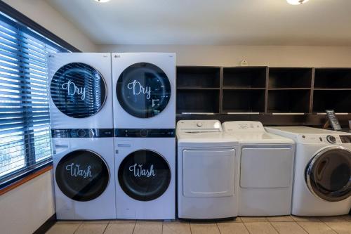 a kitchen with two refrigerators and two washing machines at Staybridge Suites Houston West - Energy Corridor by IHG in Houston