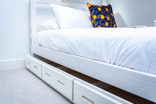 a bedroom with a white bed with white sheets at Tumbledown Condo by Revelstoke Vacations in Revelstoke