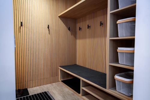 a walk in closet with wooden walls and wooden shelves at Tumbledown Condo by Revelstoke Vacations in Revelstoke