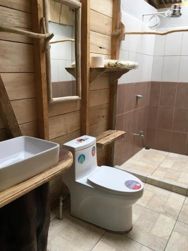 a bathroom with a toilet and a sink at Finca Avellanas in Playa Avellana