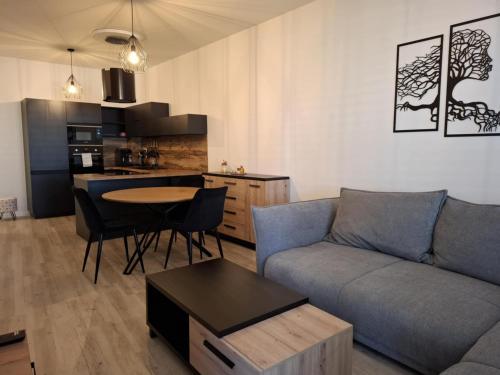 a living room with a couch and a table at ORBIS Central apartment in Nitra