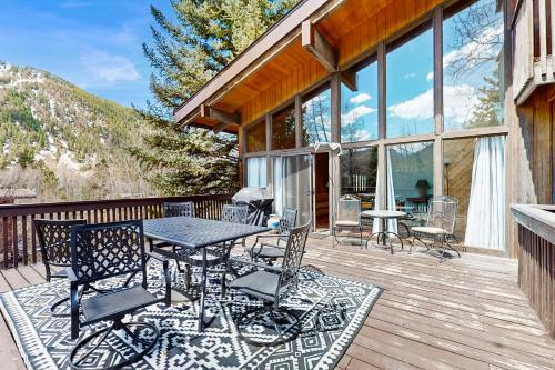 a patio with a table and chairs on a deck at Mountain Valley Hideaway in Aspen
