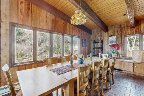 a dining room with a long table and chairs at Mountain Valley Hideaway in Aspen