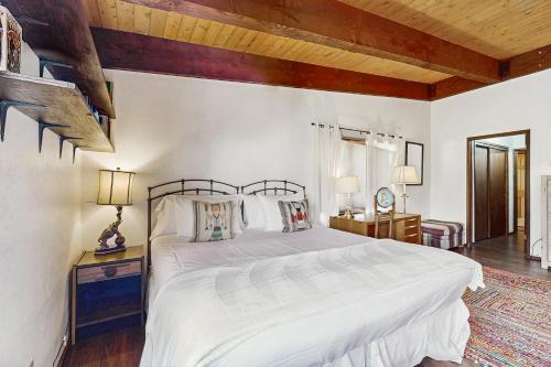 a bedroom with a white bed and a wooden ceiling at Mountain Valley Hideaway in Aspen