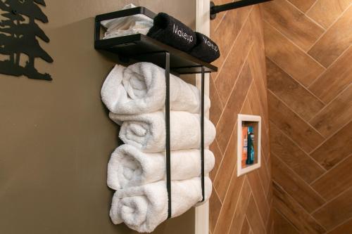 a bunch of towels on a towel rack in a bathroom at Hidden Cabin - Adventure Awaits! in Gainesville