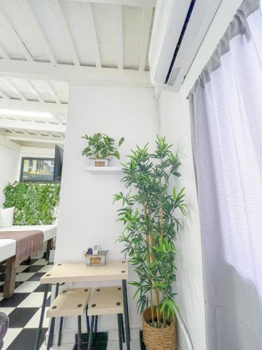 a room with a table and two potted plants at Old San Juan Rentals in San Juan