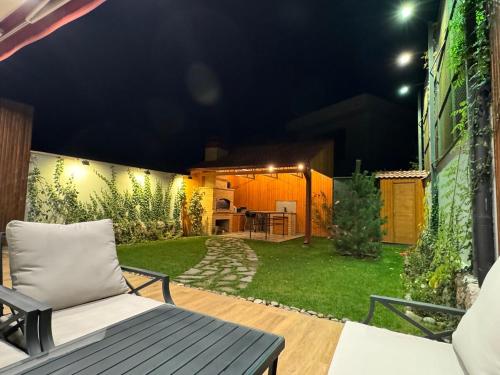 a backyard at night with a couch on a patio at LoveArmenia in Arrinj