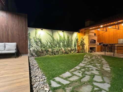 a garden with a stone walkway and grass at LoveArmenia in Arrinj