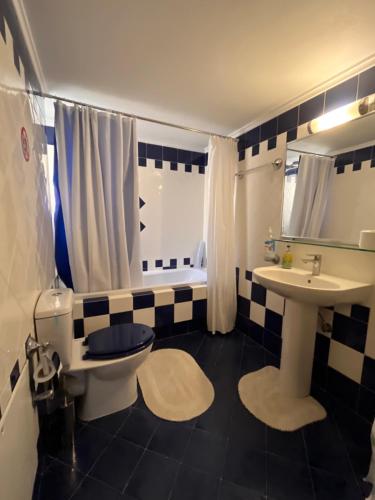 a bathroom with a toilet and a sink and a tub at C' est la vie in Nafplio