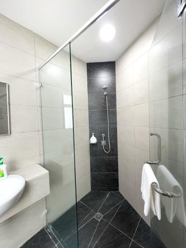 a bathroom with a shower and a sink at Ezyhouz - IMAGO The Loft in Kota Kinabalu