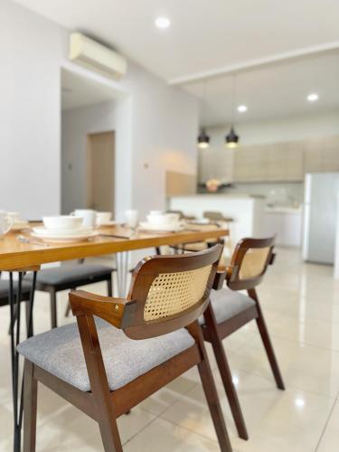 a kitchen with a wooden table and chairs at Ezyhouz - IMAGO The Loft in Kota Kinabalu