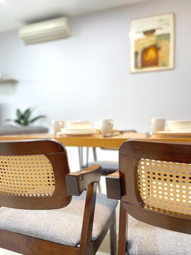 a dining room table with two chairs and a wooden table at Ezyhouz - IMAGO The Loft in Kota Kinabalu
