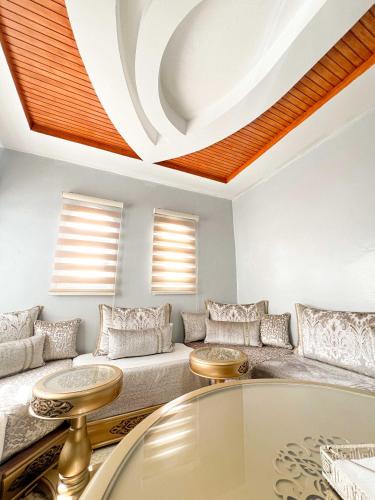 a living room with a couch and a table at An elegant apartment in Essaouira