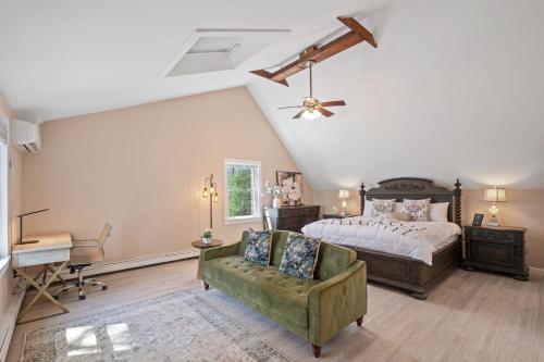 a bedroom with a bed and a chair and a desk at Riverfront Retreat in Wareham in Wareham
