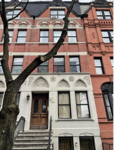 a building with a tree in front of it at NYC Townhouse Apartment in New York