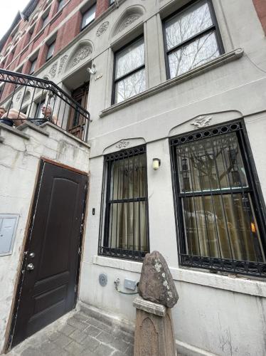 a building with a statue in front of it at NYC Townhouse Apartment in New York
