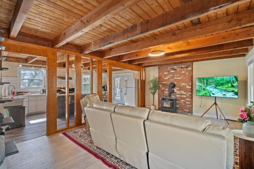 a living room with a couch and a fireplace at Riverfront Retreat in Wareham in Wareham