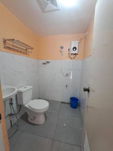 a bathroom with a toilet and a sink at Apo Licz Transient 3C in Baguio