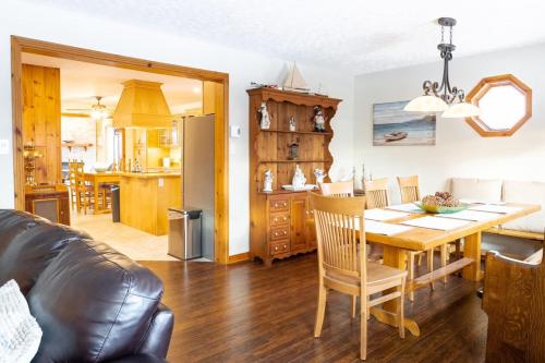 a living room and kitchen with a table and chairs at Get A Way Beach Chalet in Cocagne 