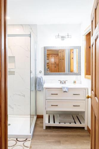 a bathroom with a sink and a shower at Get A Way Beach Chalet in Cocagne 