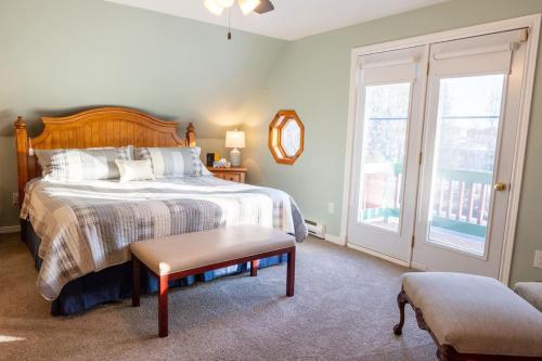 a bedroom with a bed and a chair and a window at Get A Way Beach Chalet in Cocagne 