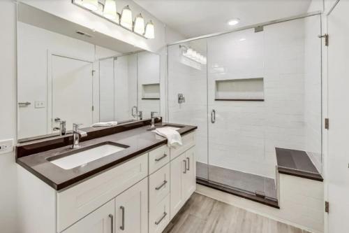 a bathroom with a sink and a large mirror at Monthly and Seasonal Luxury Lakefront 5 Bedroom 5 Bath Estate in Ingleside