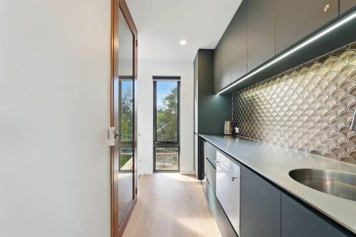 a kitchen with a sink and a counter top at Modern Coastal Retreat and Hot Tub in Carlton