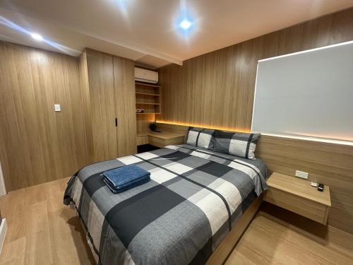 a bedroom with a large bed with a blank screen at Sydney Premium Studio Renovated 2025 in Sydney