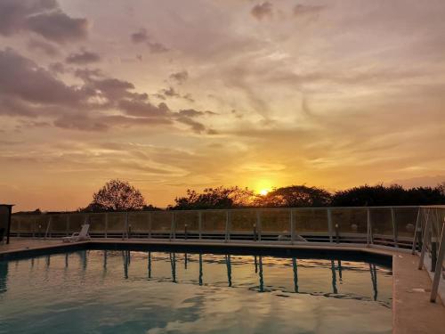 a swimming pool with a sunset in the background at The Sunny Loft Coronado Ph Ibiza in Playa Coronado