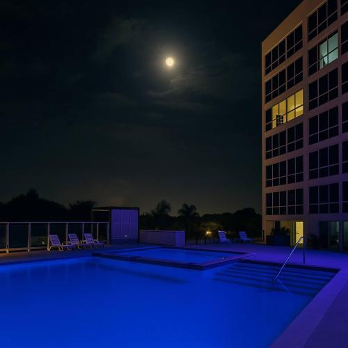 an empty swimming pool at night with a building at The Sunny Loft Coronado Ph Ibiza in Playa Coronado