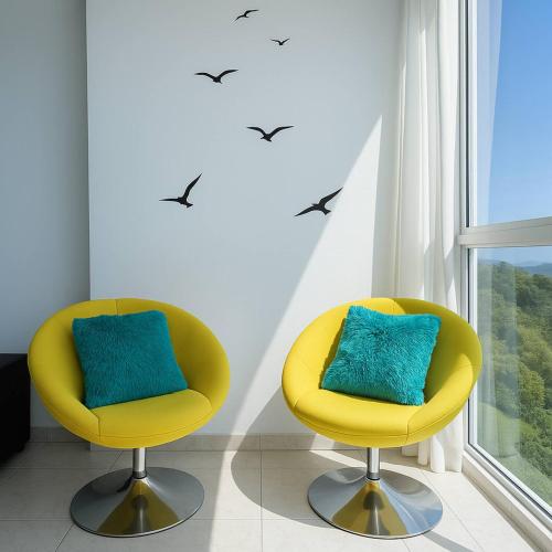 two yellow chairs in a room with birds on the wall at The Sunny Loft Coronado Ph Ibiza in Playa Coronado
