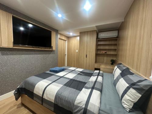 a bedroom with a bed and a flat screen tv at Sydney Premium Studio Renovated 2025 in Sydney