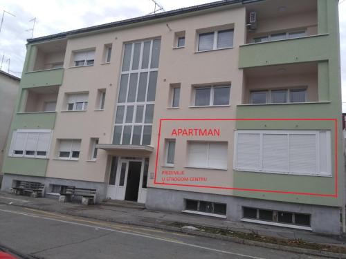 an apartment building on the side of a street at Studio apartman Senka in Daruvar