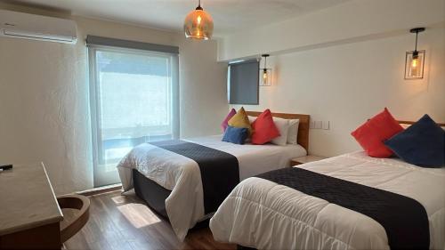 Giường trong phòng chung tại Hotel Consulado