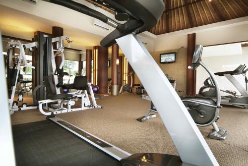 a gym with treadmills and elliptical machines at Villa Mahapala in Sanur