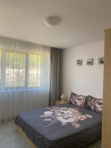a bedroom with a large bed with a blue blanket at Beachfront, 2 Bed with Sea Views in Elenite