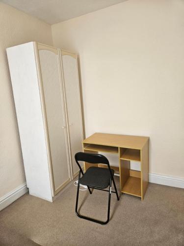 an empty room with a desk and a chair at Comfort, Convenience & Style in Preston