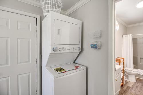 a white refrigerator in a kitchen with a basketball hoop at Bring Your Boat Retreat Near Lake Guntersville in Guntersville