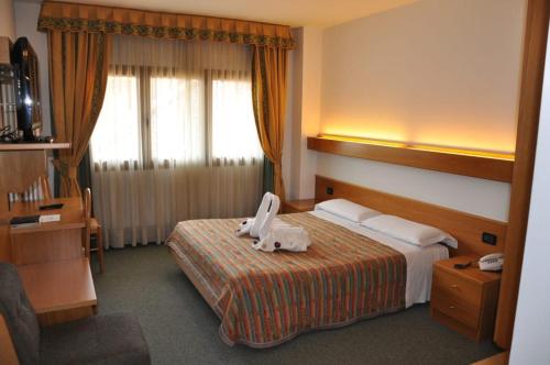 a hotel room with a bed with a machine on it at Liberty Hotel Malé in Malè