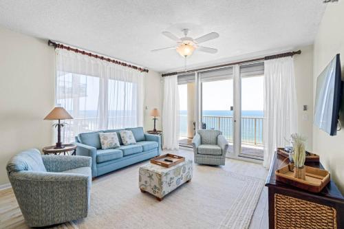 a living room with a blue couch and chairs at Beach Club D-1201 in Gulf Shores