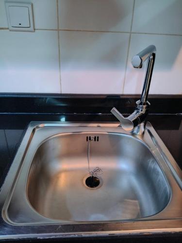 a sink in a kitchen with a faucet at Sea View Studio 4 Royal Breeze Breezeسي ويو ستوديو رويال بريز in Ras al Khaimah